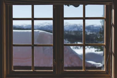 Wooden window with snowy winter landscape view